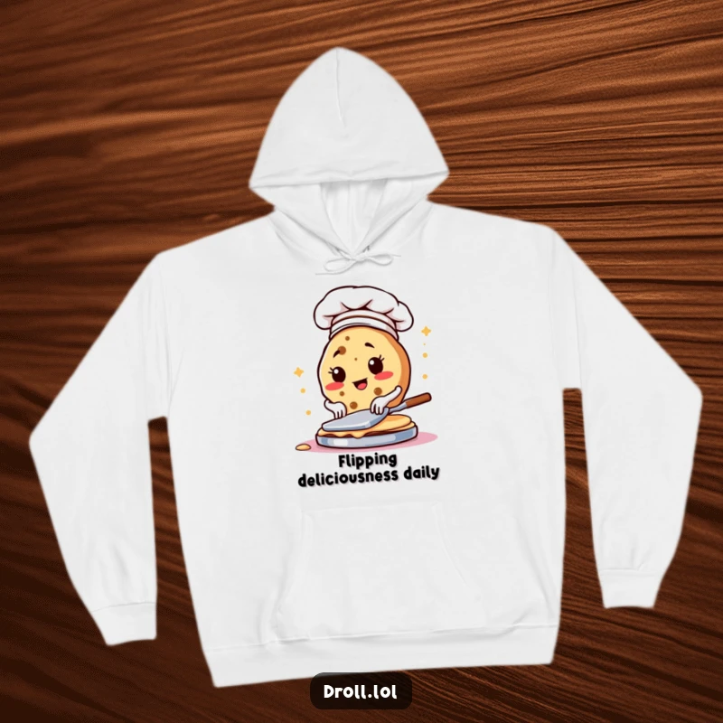 Funny hoodie depicting a determined cookie chef flipping pancakes, ideal for kitchen warmth and humor.