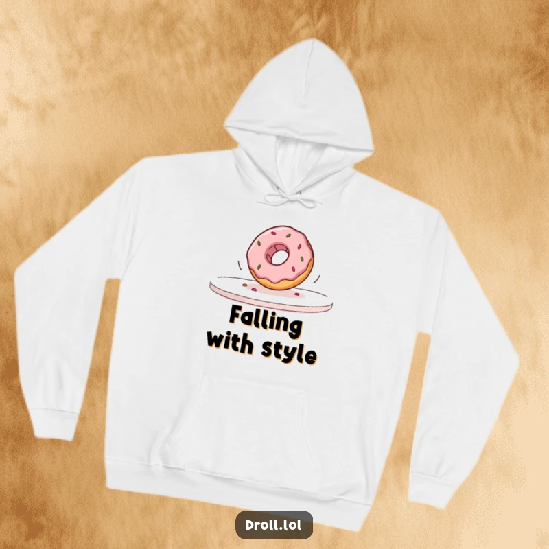 Funny donut falling off a table in slow motion printed on a soft hoodie, offering warmth and humor.