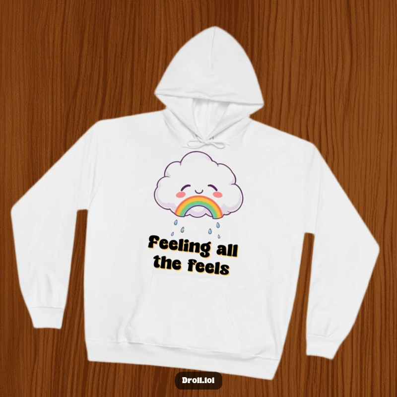 Funny hoodie showcasing a fluffy cloud crying tears of joy, forming a beautiful small rainbow, perfect for cozy, happy moments.