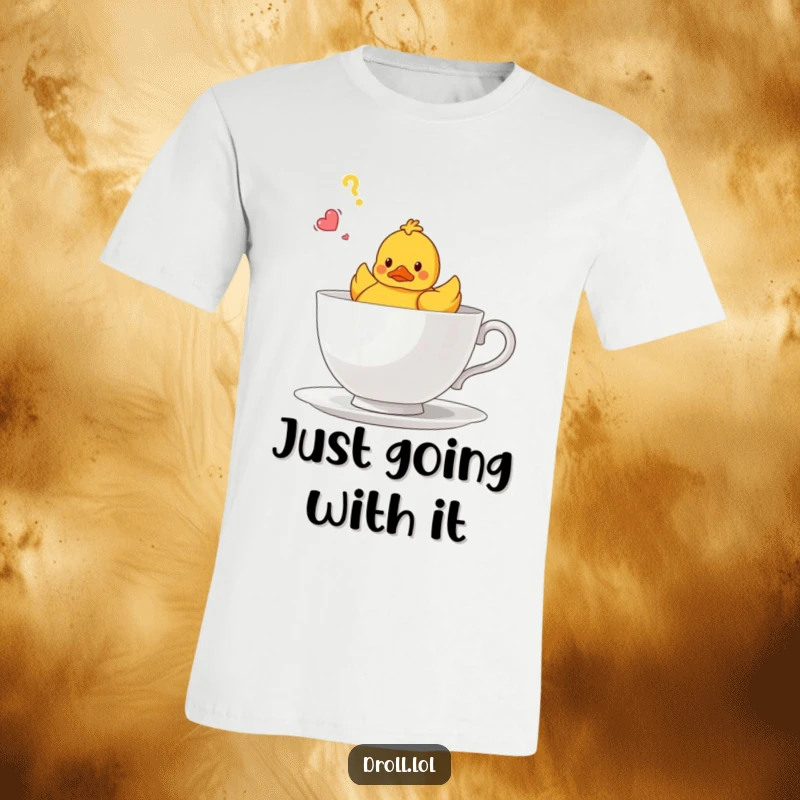 Funny T-shirt with a small rubber duck looking utterly confused while floating in a massive teacup, capturing a humorous moment.