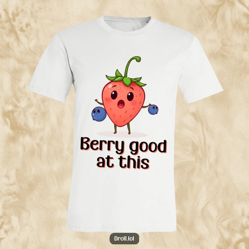 Funny t-shirt depicting a surprised strawberry artistically juggling small blueberries with great enthusiasm, a comical fruit performance.