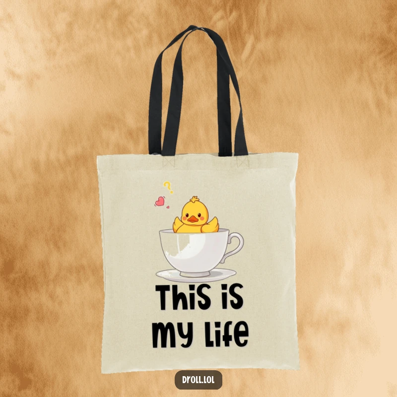 Funny tote bag illustrating a small rubber duck looking bewildered in a oversized teacup, practical and humorous.